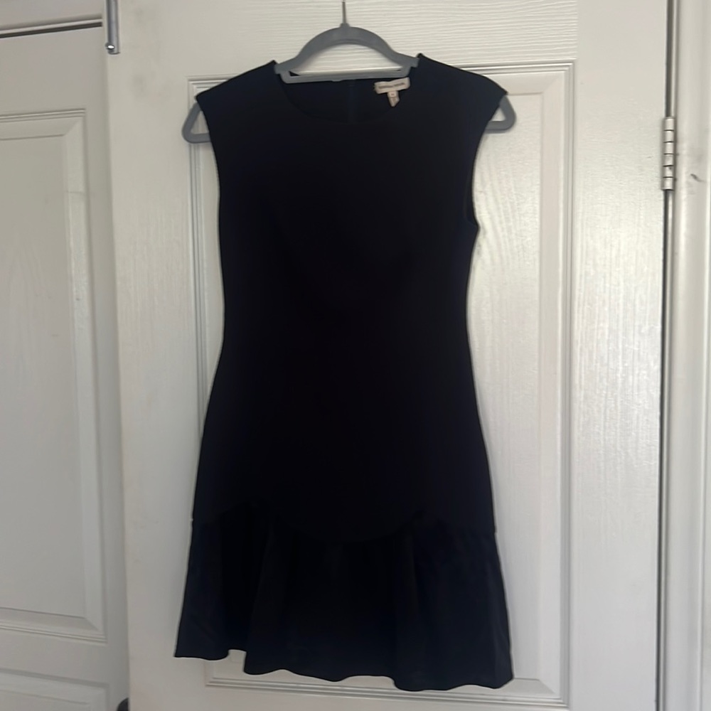 Navy fit and flare knit dress with satin ruffle at hem.